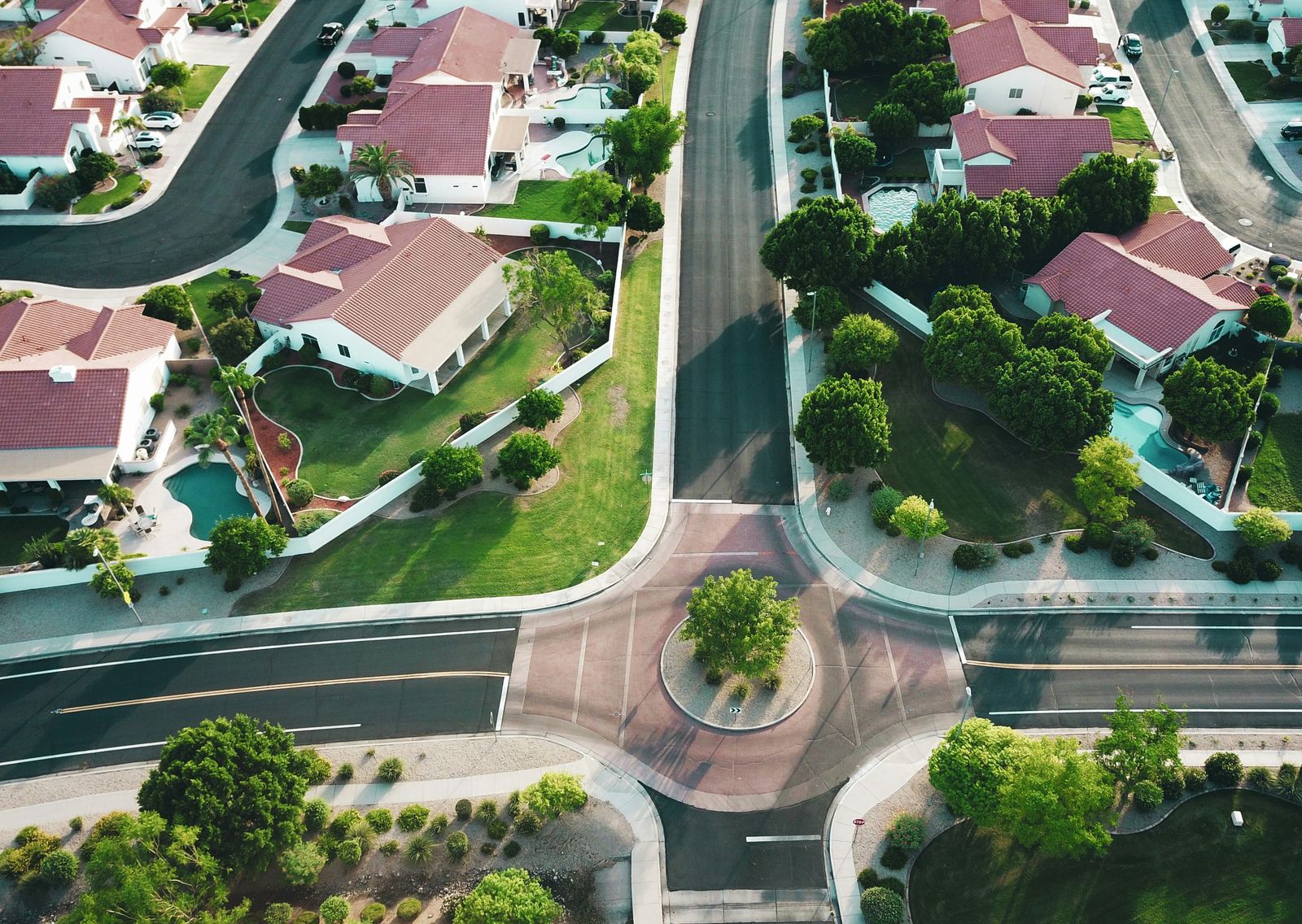 Aerial view of a gated residential community with landscaped lawns