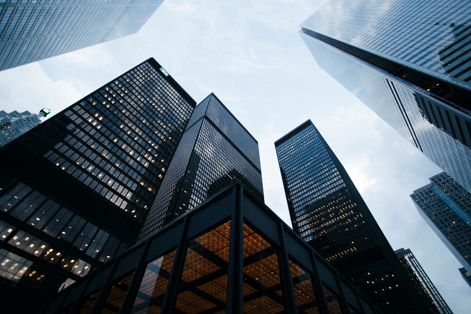 View looking up at modern glass office towers in a business district