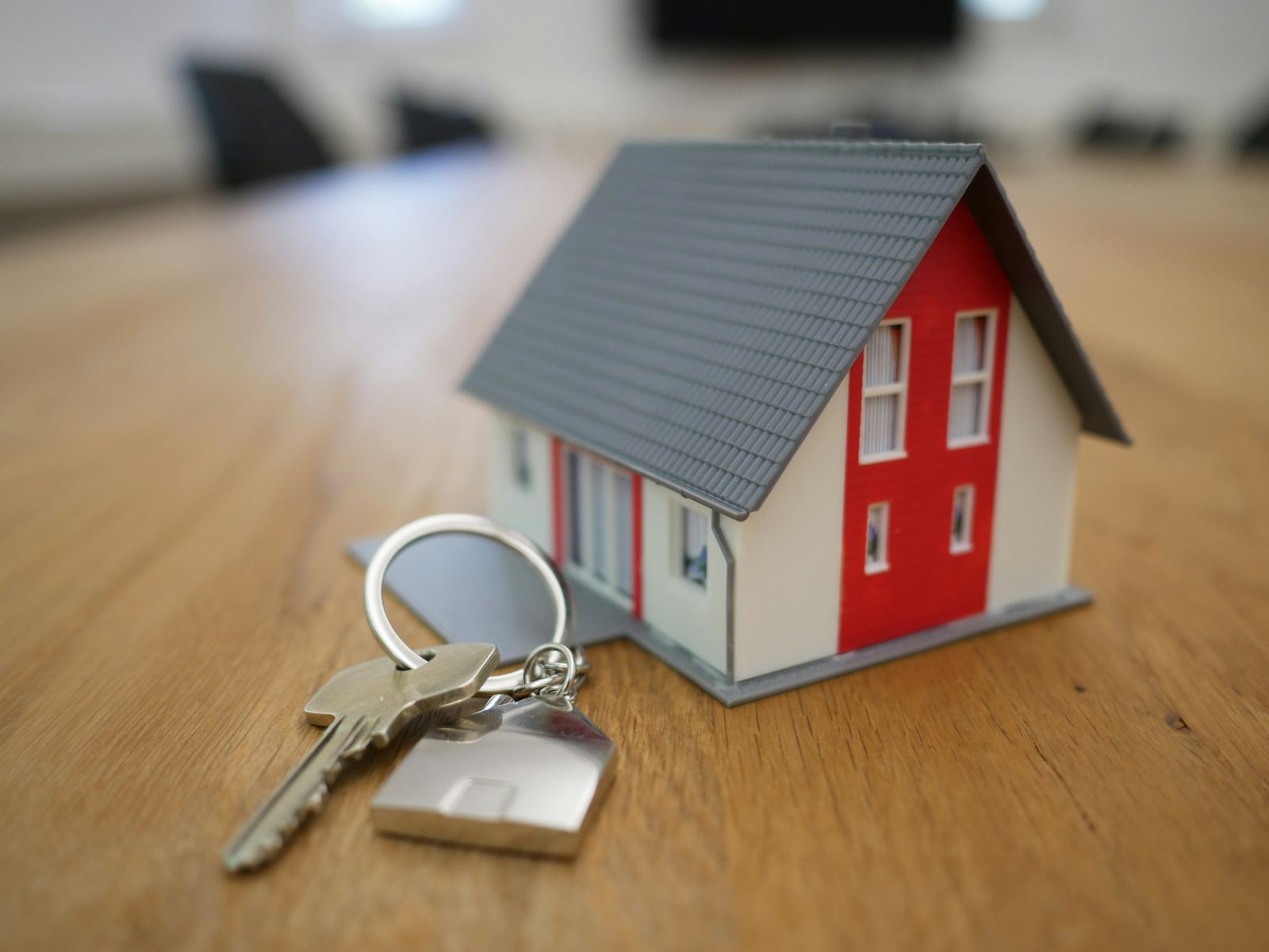 Keys to a new home resting on a wooden table, symbolizing a completed purchase